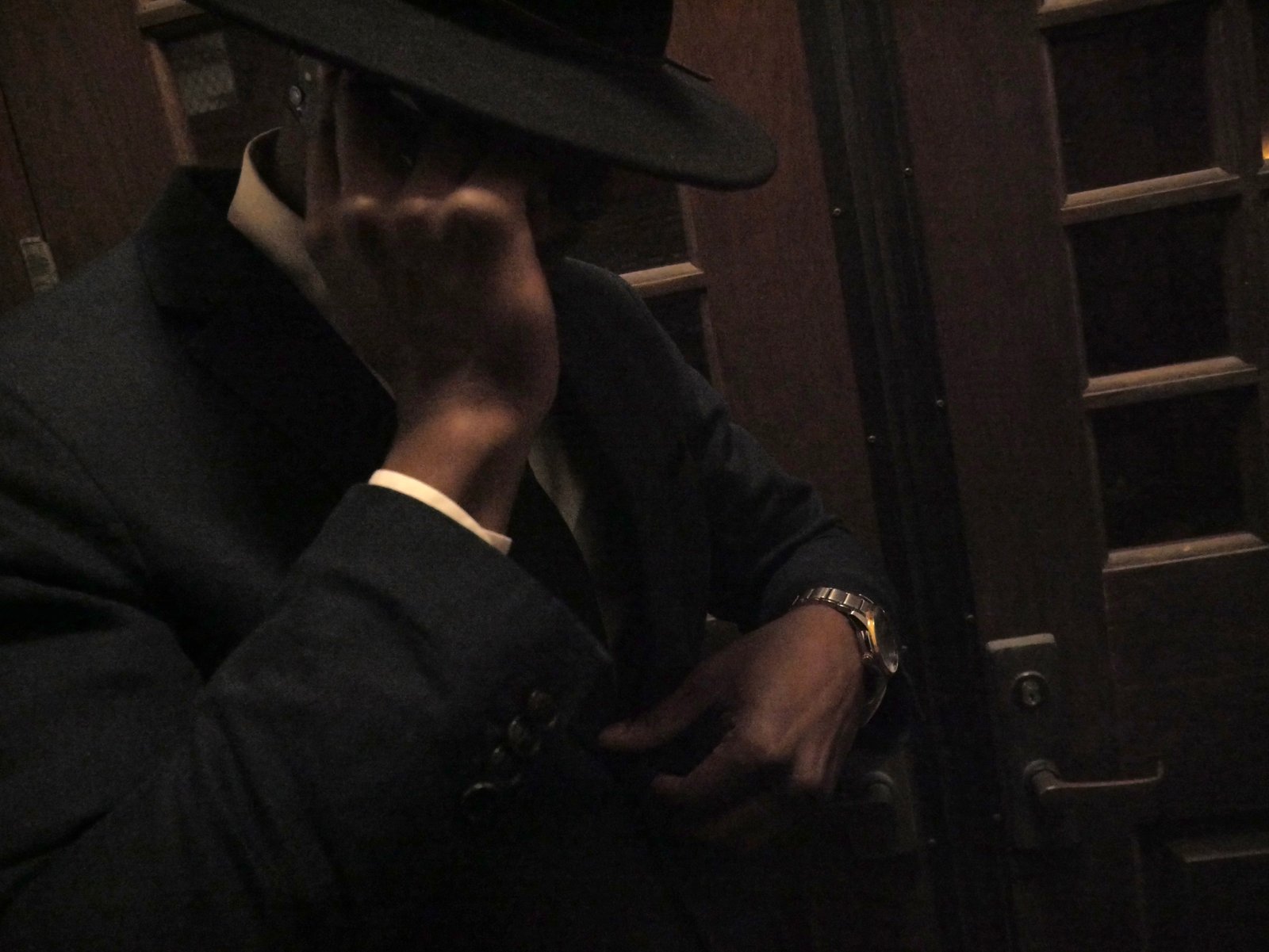 Low-light portrait, suit and fedora